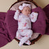 Baby wearing Coral Organic Growsuit | Snuggle Hunny