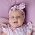 Baby wearing Coral Organic Topknot | Snuggle Hunny